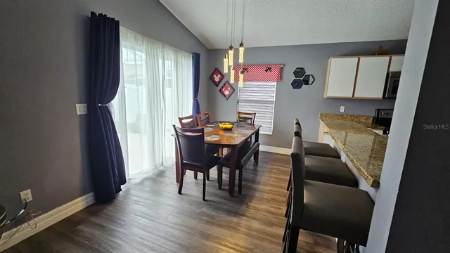 a dining room with furniture and window