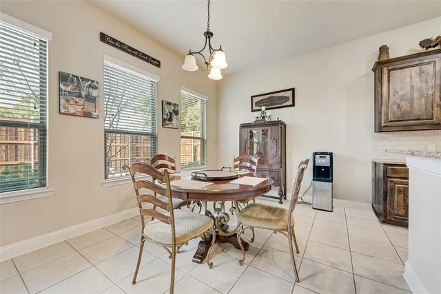 a kitchen with granite countertop a refrigerator and a stove top oven