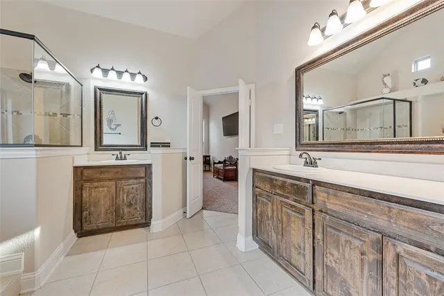 a bathroom with a tub sink and mirror