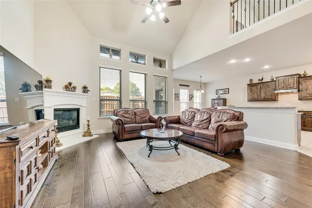 a living room with furniture a fireplace and a large window