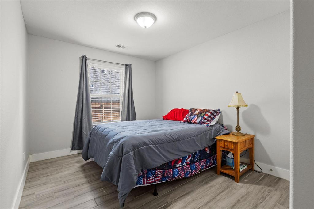 608 East Shepherd Street Denison, TX 75021 - Photo 25 of 31 Room featuring light gray walls, wood-finish flooring, and a ceiling-mounted light fixture