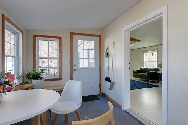 a view of a livingroom with furniture window and wooden floor
