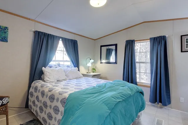 a bedroom with a large bed and a window