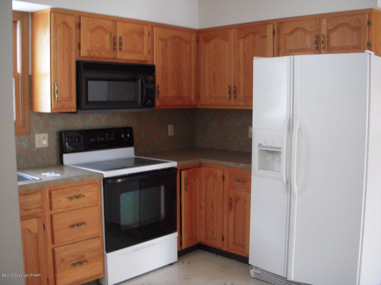 1227 Salisbury Road Bushkill, PA 18324 - Photo 4 of 15 a kitchen with granite countertop white cabinets and stainless steel appliances