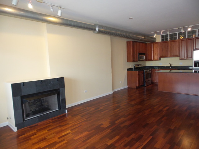 1200 West Monroe Street, Unit 803 Chicago, IL 60607 - Photo 2 of 12 a view of kitchen with wooden floor and electronic appliances