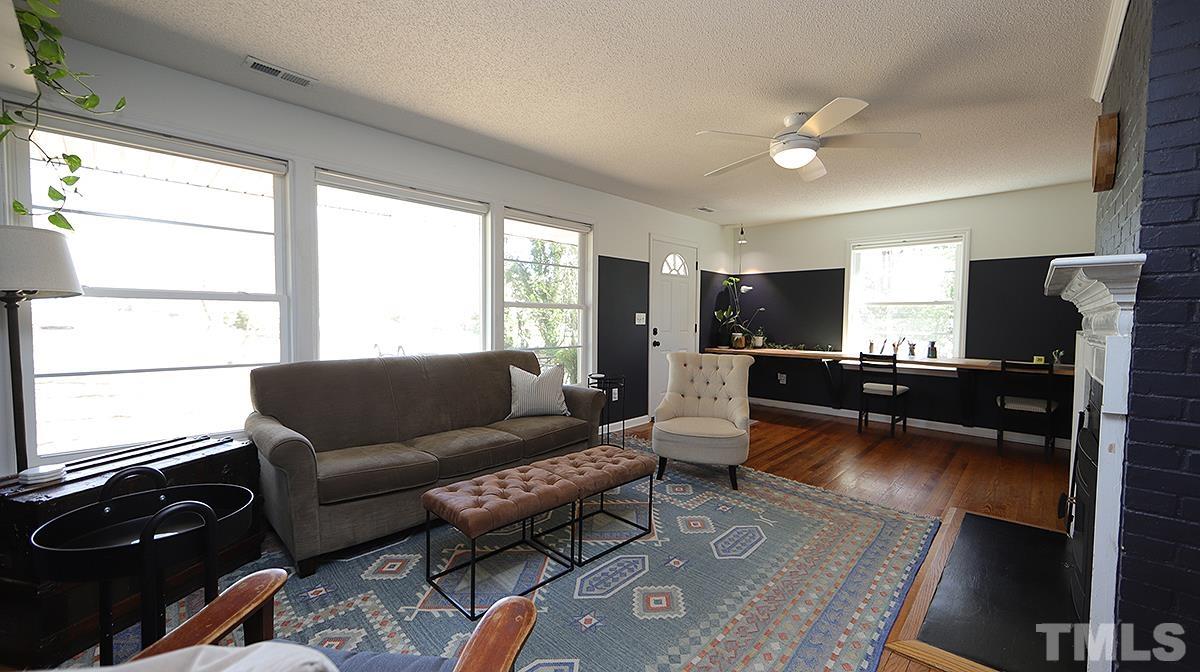 1010 Southerlund Road Garner, NC 27529 - Photo 3 of 20 a living room with furniture and a flat screen tv