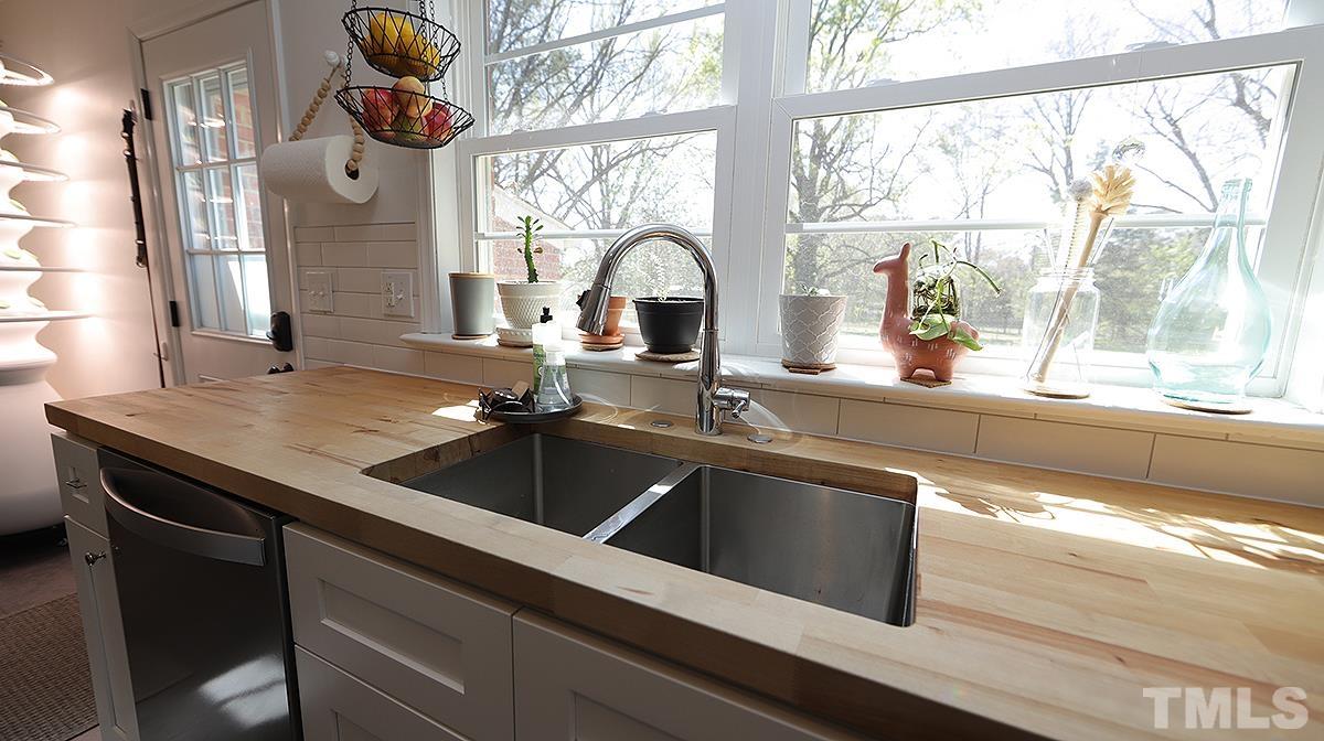 1010 Southerlund Road Garner, NC 27529 - Photo 8 of 20 a kitchen with a sink and a large window