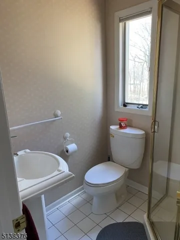 a white toilet sitting next to a window