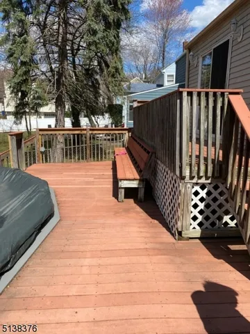 a view of a house with wooden floor roof and wooden fence