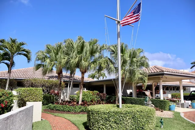 a view of swimming pool with palm trees