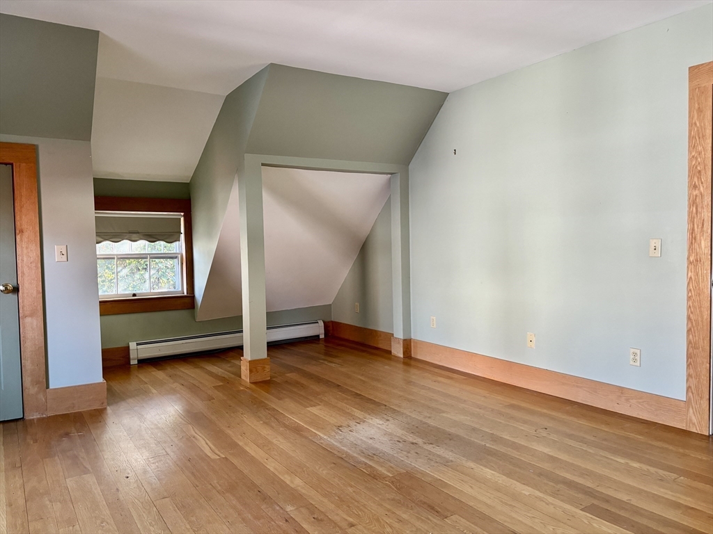 527 Main Street, Unit 2 Ashfield, MA 01330 - Photo 11 of 27 an empty room with wooden floor and windows