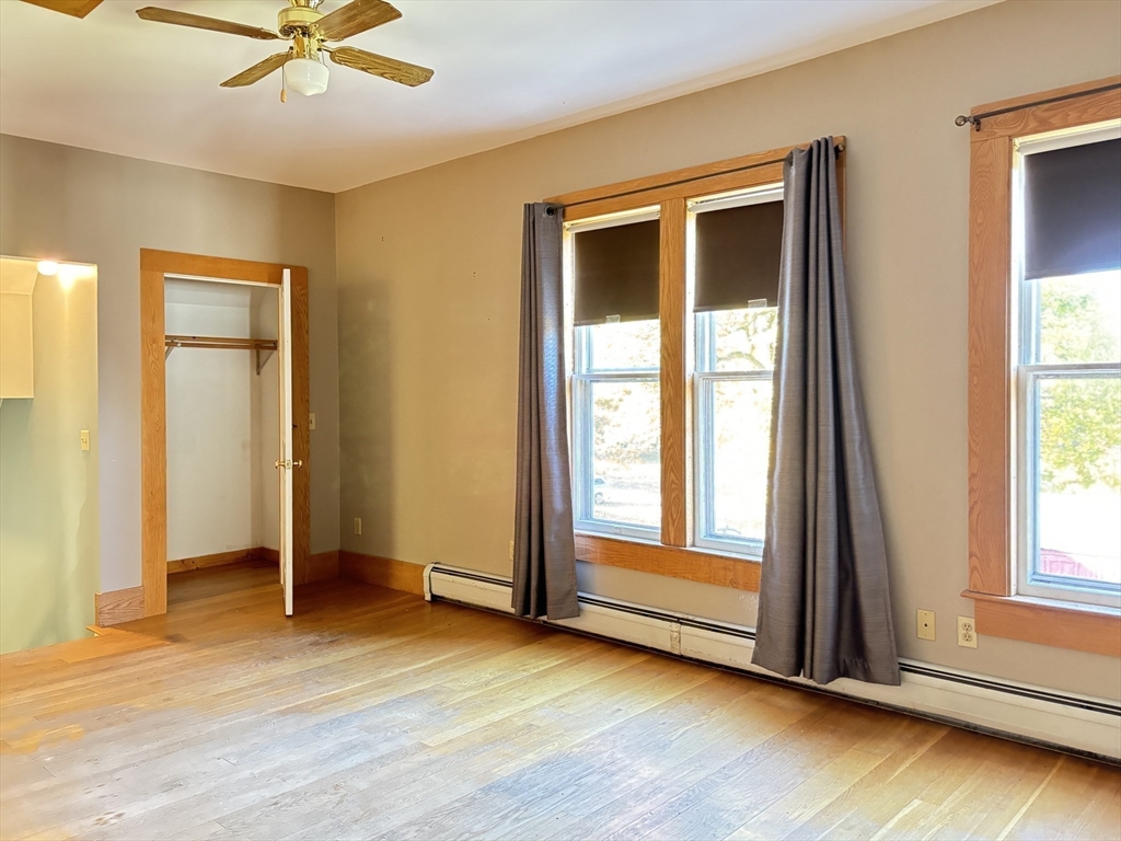 527 Main Street, Unit 2 Ashfield, MA 01330 - Photo 12 of 27 an empty room with wooden floor and a window