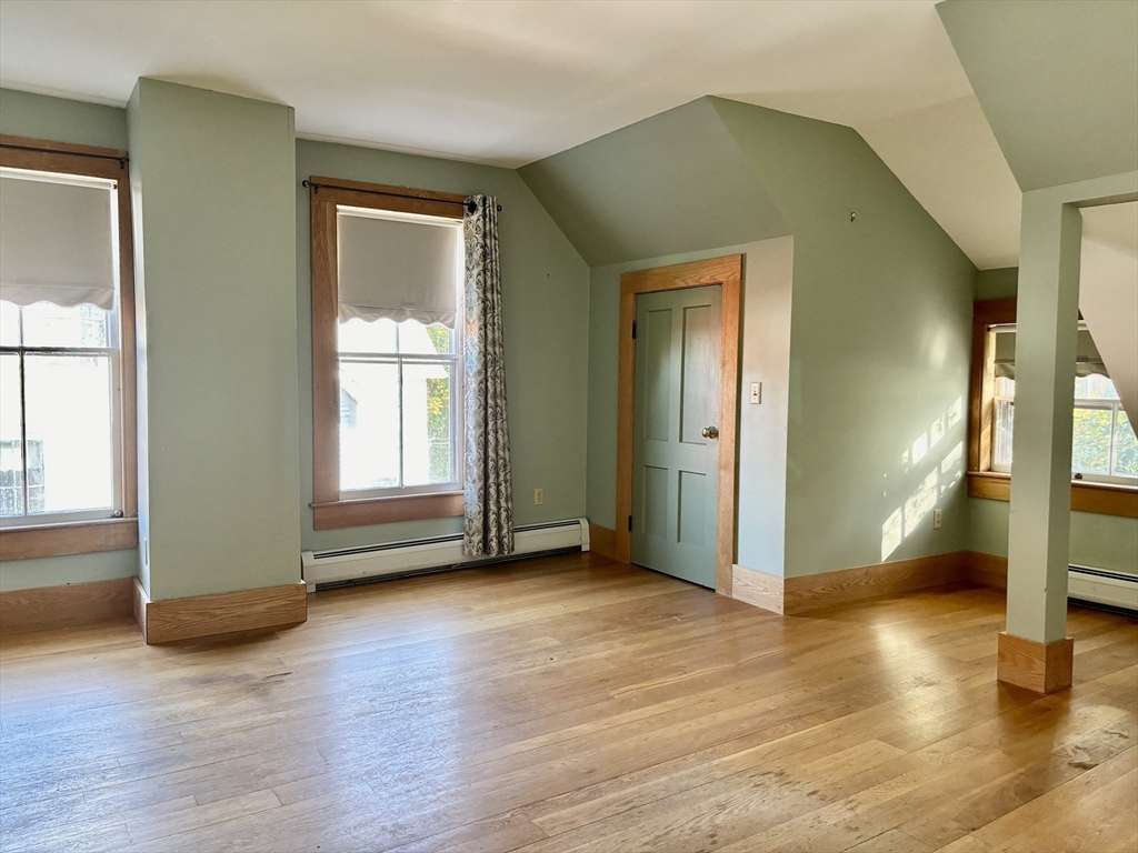 527 Main Street, Unit 2 Ashfield, MA 01330 - Photo 13 of 27 an empty room with wooden floor and windows