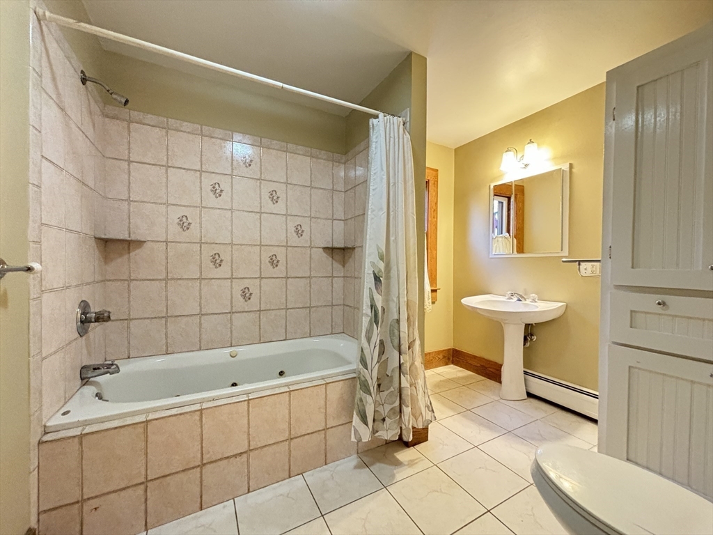 527 Main Street, Unit 2 Ashfield, MA 01330 - Photo 21 of 27 a bathroom with a bathtub and a sink