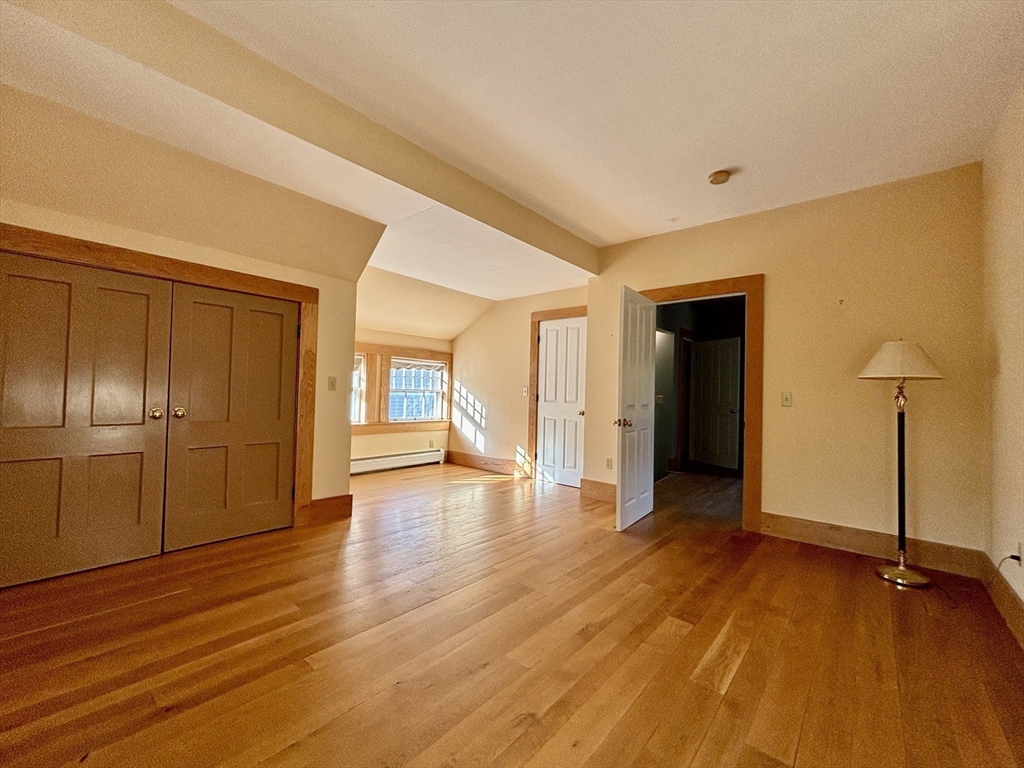 527 Main Street, Unit 2 Ashfield, MA 01330 - Photo 8 of 27 a view of an empty room with window and wooden floor