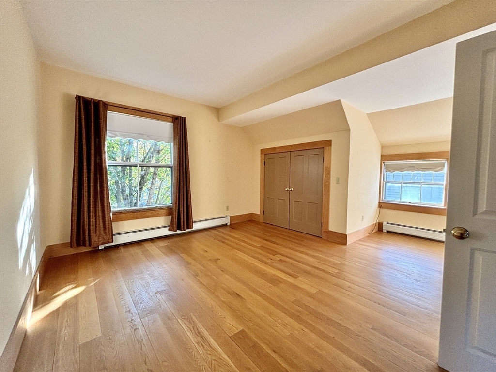 527 Main Street, Unit 2 Ashfield, MA 01330 - Photo 9 of 27 an empty room with wooden floor and windows