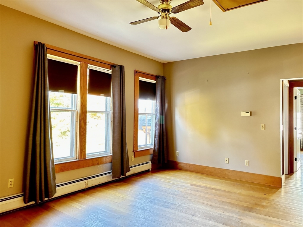 527 Main Street, Unit 2 Ashfield, MA 01330 - Photo 10 of 27 a view of an empty room with wooden floor and a window