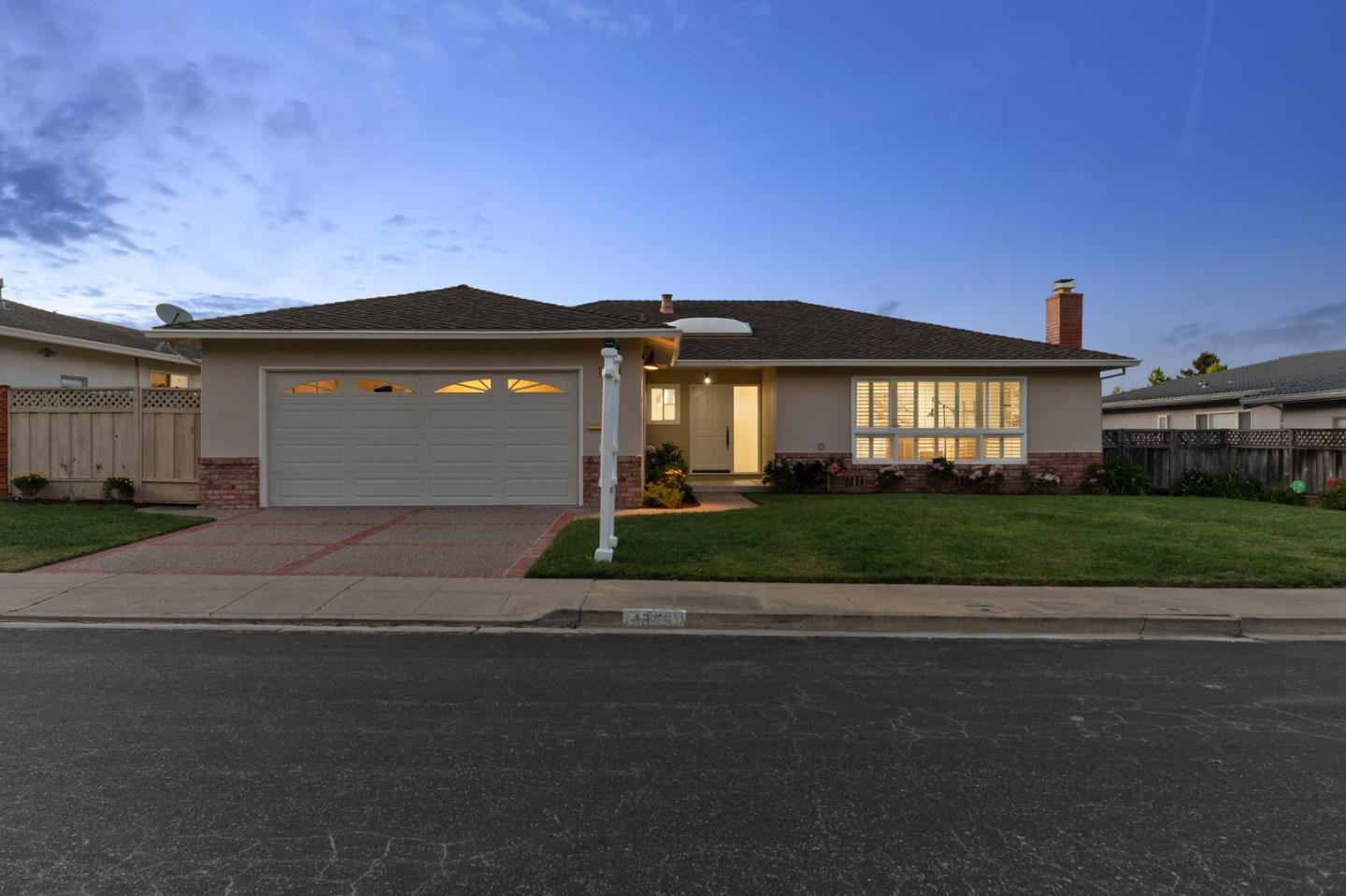 a front view of a house with a yard and a garage
