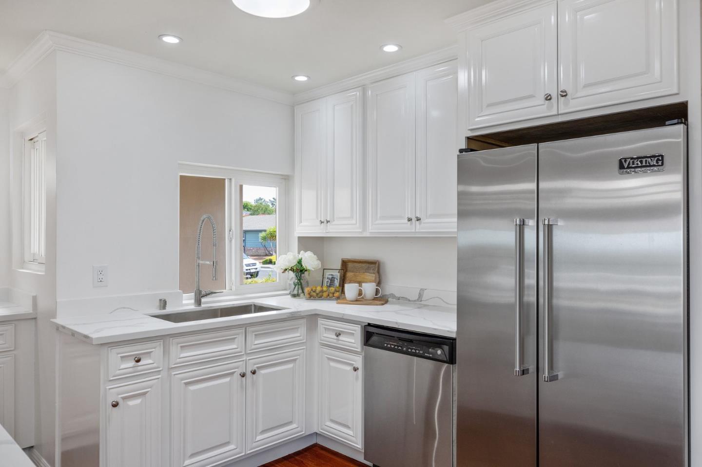 1808 Castenada Drive Burlingame, CA 94010 - Photo 12 of 37 a kitchen with a refrigerator sink and cabinets