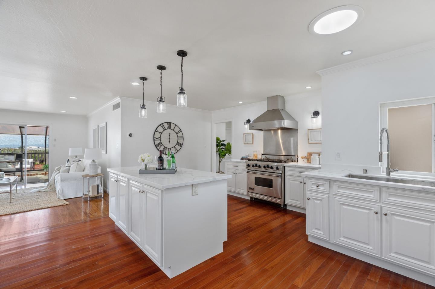 1808 Castenada Drive Burlingame, CA 94010 - Photo 14 of 37 a kitchen with stainless steel appliances a stove top oven and cabinets