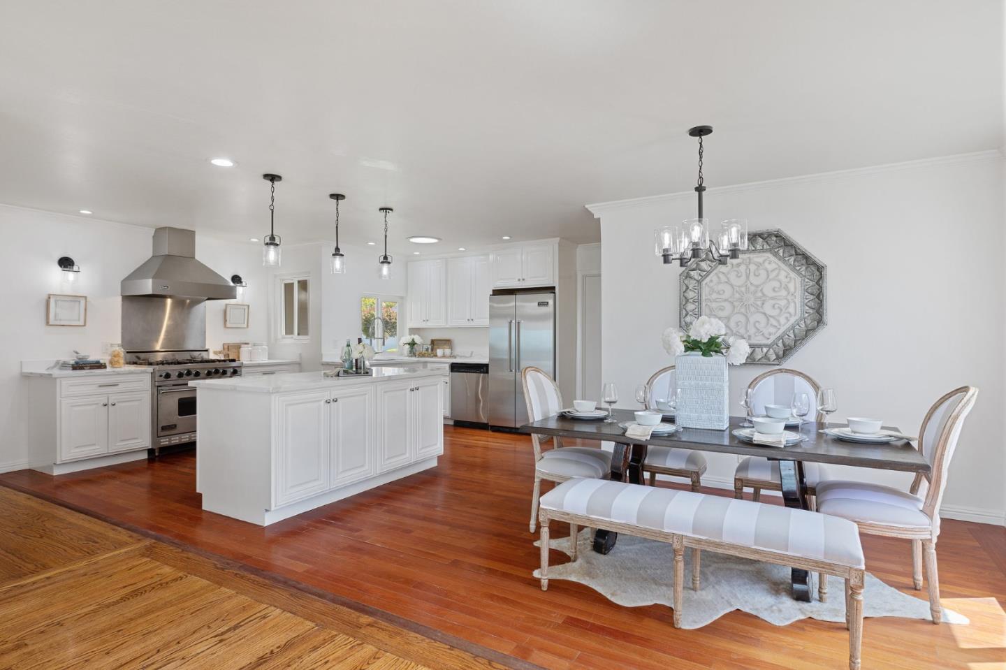1808 Castenada Drive Burlingame, CA 94010 - Photo 15 of 37 a kitchen with stainless steel appliances kitchen island granite countertop a table chairs and a wooden floor