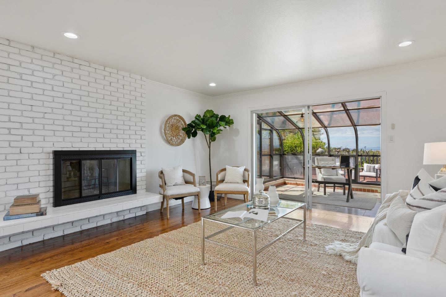 1808 Castenada Drive Burlingame, CA 94010 - Photo 19 of 37 a living room with furniture a fireplace and a floor to ceiling window