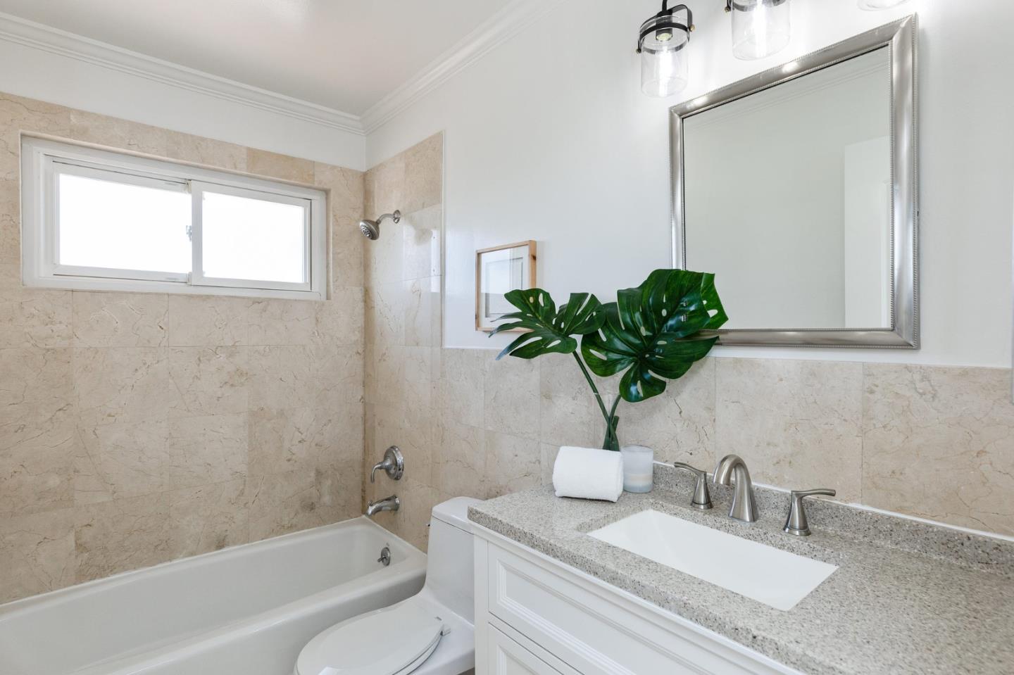 1808 Castenada Drive Burlingame, CA 94010 - Photo 20 of 37 a bathroom with a granite countertop sink a mirror and a bathtub