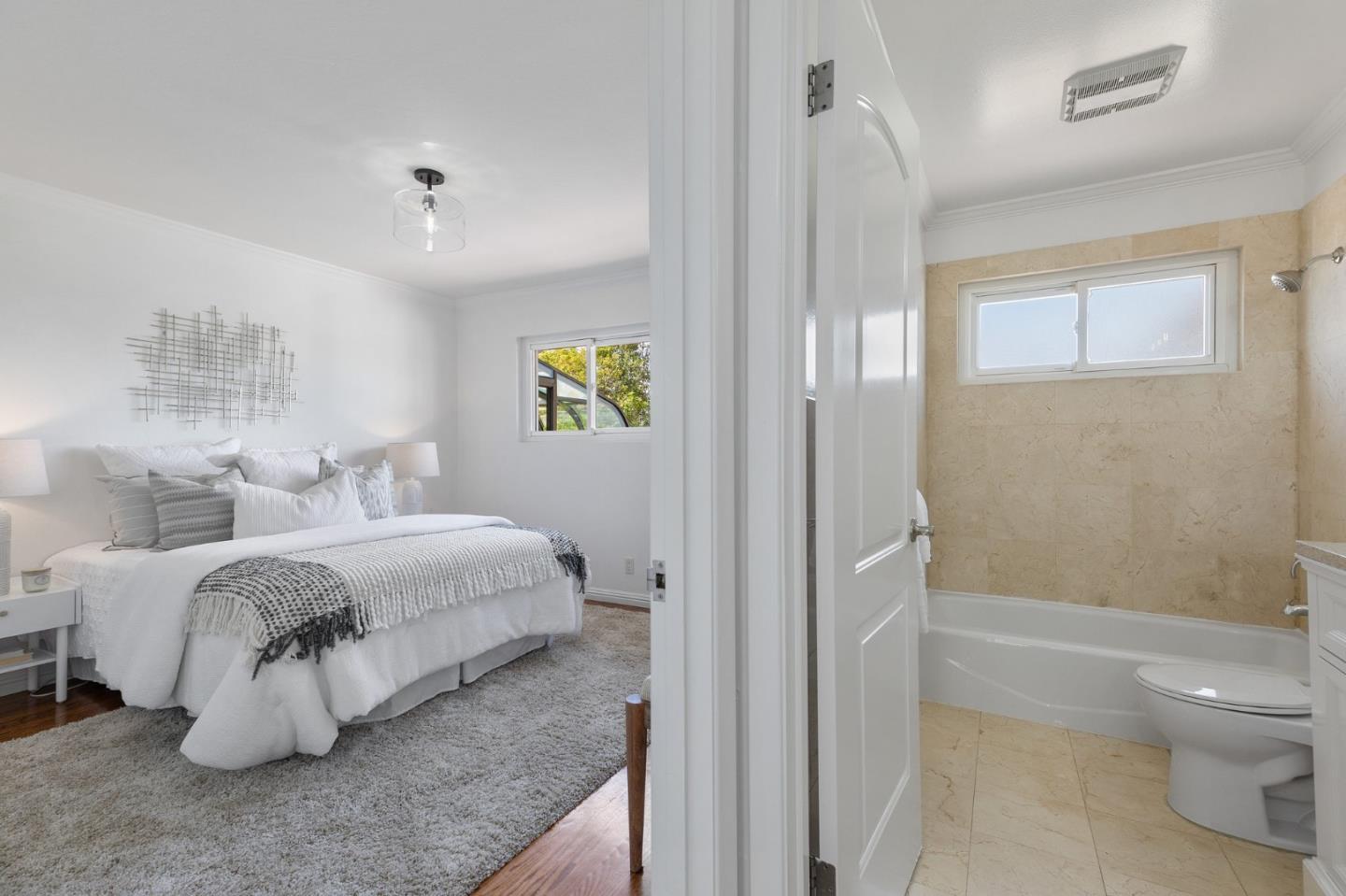 1808 Castenada Drive Burlingame, CA 94010 - Photo 21 of 37 a spacious bedroom with a bed and a window