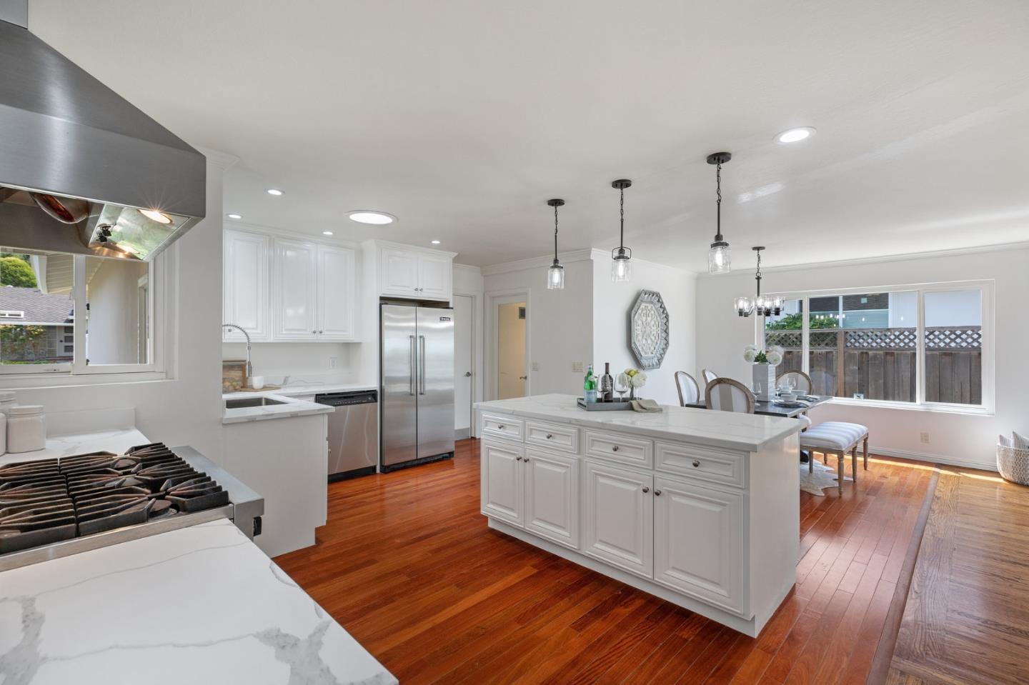 1808 Castenada Drive Burlingame, CA 94010 - Photo 9 of 37 a open kitchen with stainless steel appliances granite countertop a stove and white cabinets with wooden floor