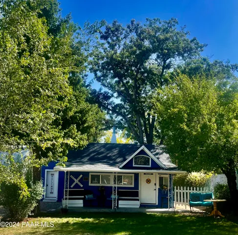 a view of house with yard in front of it