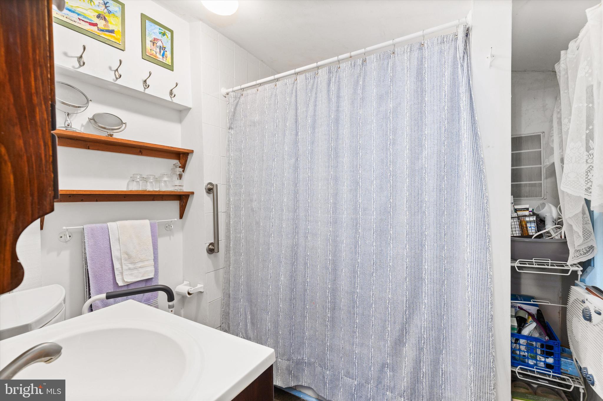 4665 Tyaskin Road Tyaskin, MD 21865 - Photo 16 of 40 a bathroom with a sink and a mirror