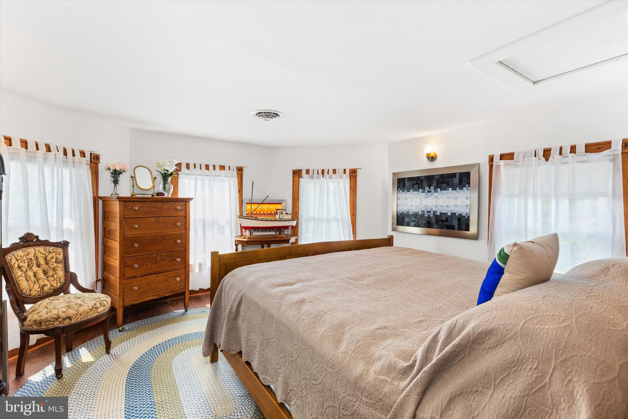 4665 Tyaskin Road Tyaskin, MD 21865 - Photo 27 of 40 a bedroom with a bed a couch and a dresser