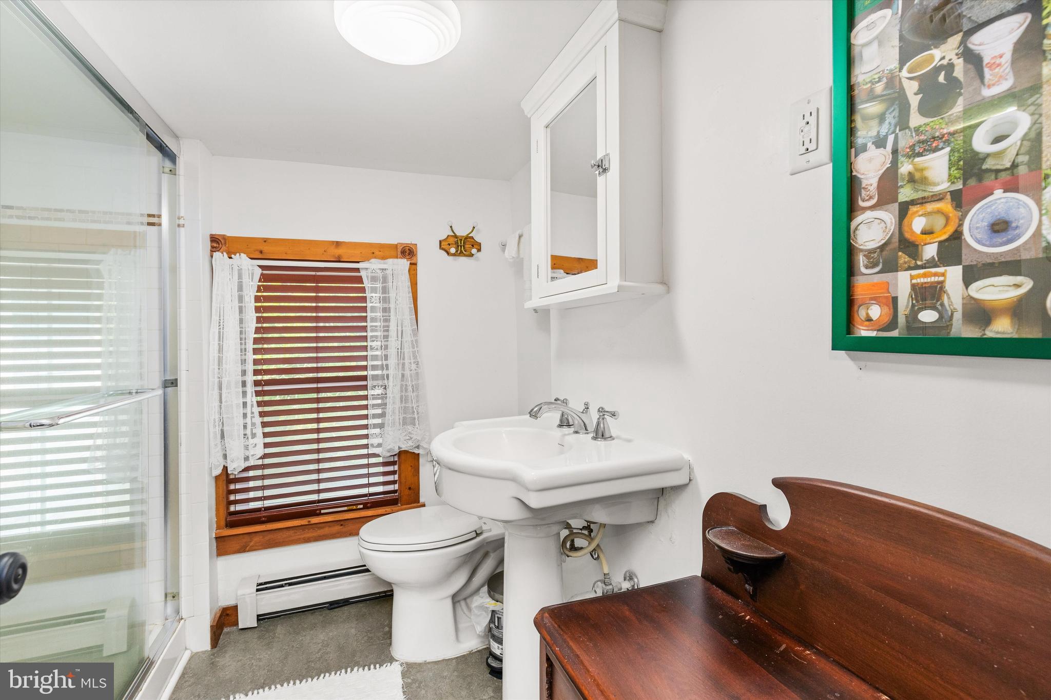 4665 Tyaskin Road Tyaskin, MD 21865 - Photo 30 of 40 a bathroom with a sink a mirror and a toilet