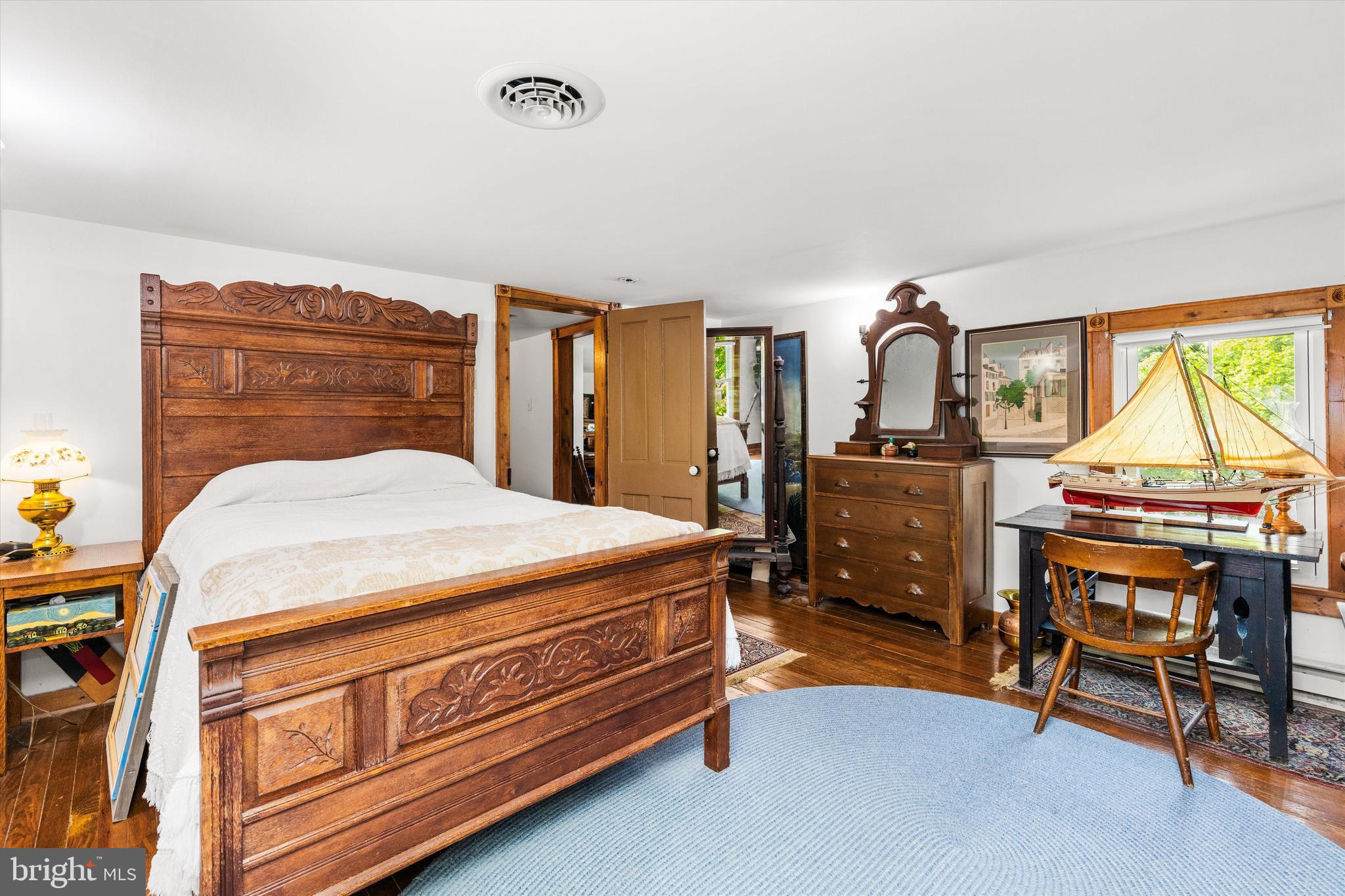 4665 Tyaskin Road Tyaskin, MD 21865 - Photo 35 of 40 a bedroom with a bed and a chandelier