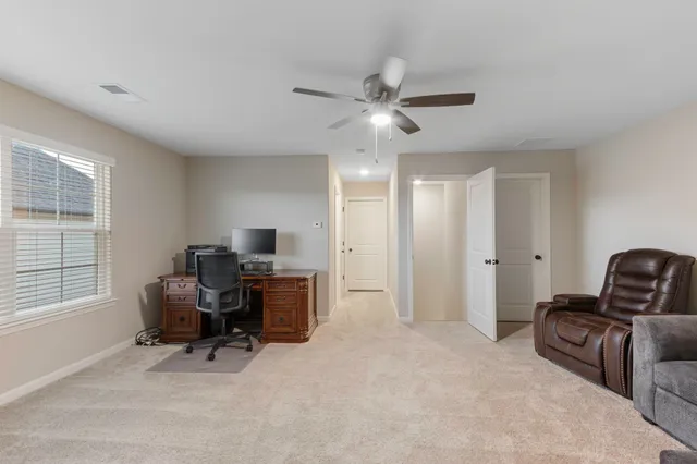 a view of a livingroom with workspace and a window