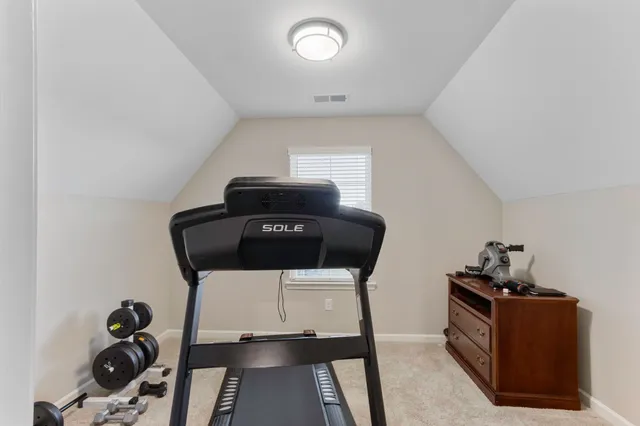 a kitchen with a stove and wooden floor