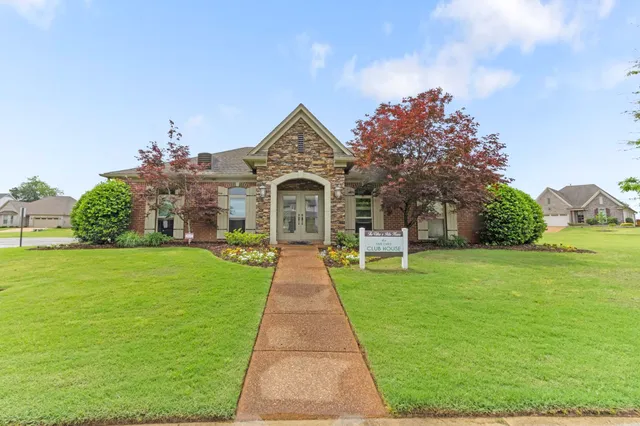 a front view of a house with garden