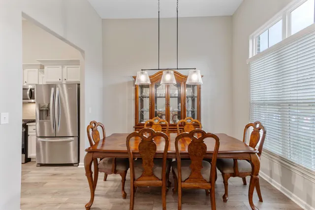 a dining room with furniture and window