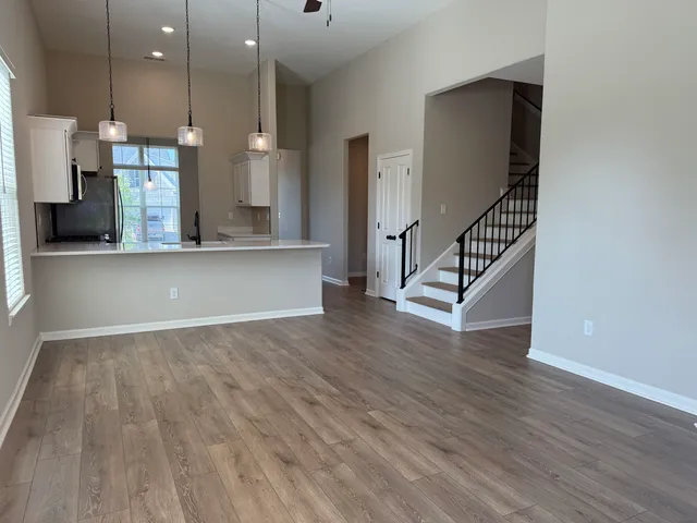 a view of a room with wooden floor and staircase