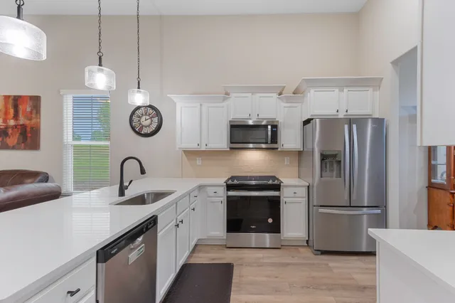 a kitchen with a refrigerator a sink and dishwasher