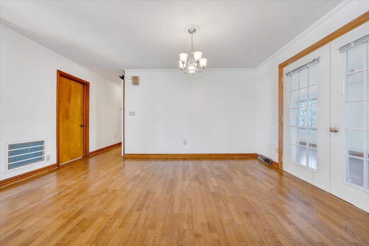 3400 Dillons Fork Road Fieldale, VA 24089 - Photo 11 of 45 a view of an empty room with wooden floor and a window