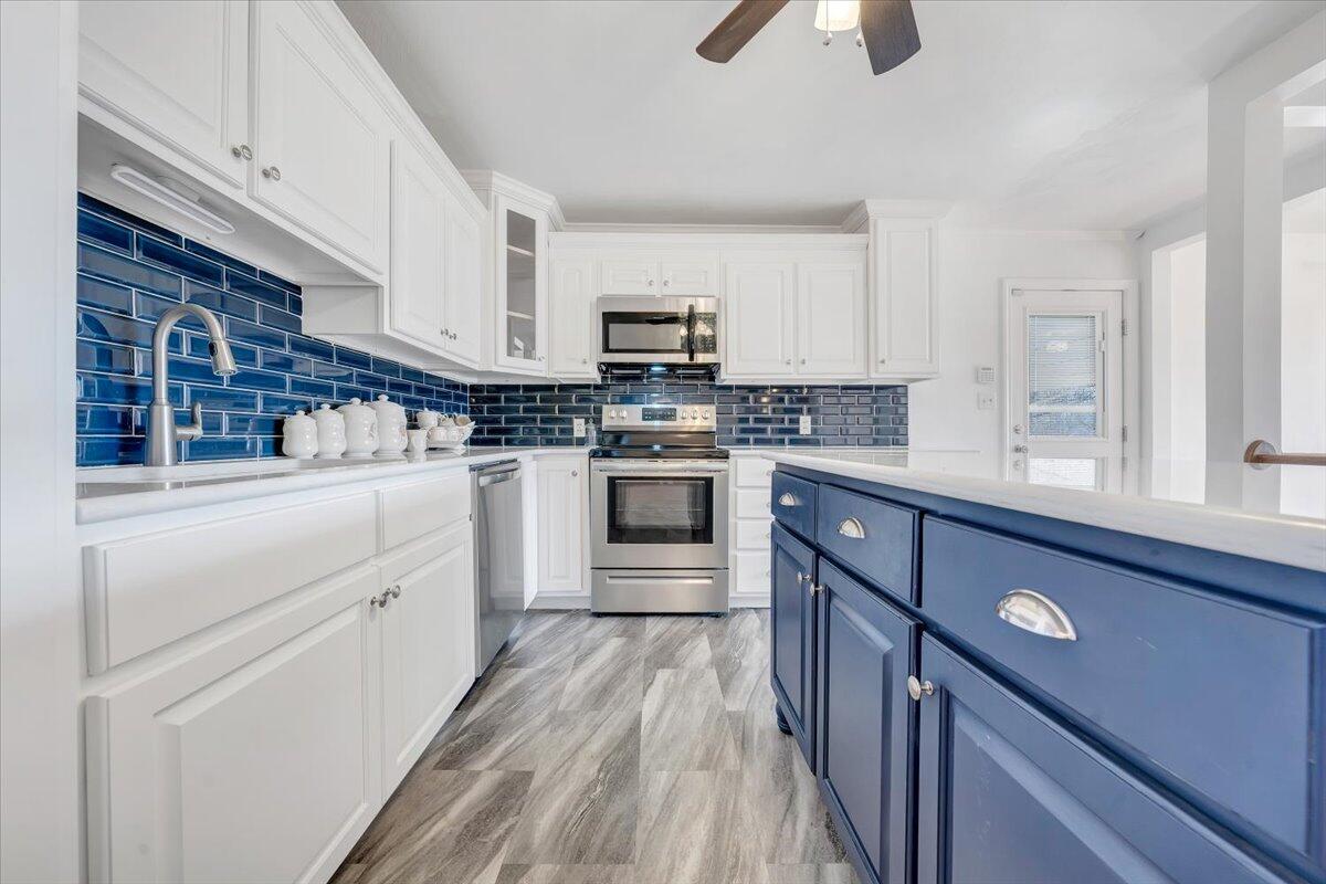 3400 Dillons Fork Road Fieldale, VA 24089 - Photo 13 of 45 a kitchen with white cabinets stainless steel appliances and a window