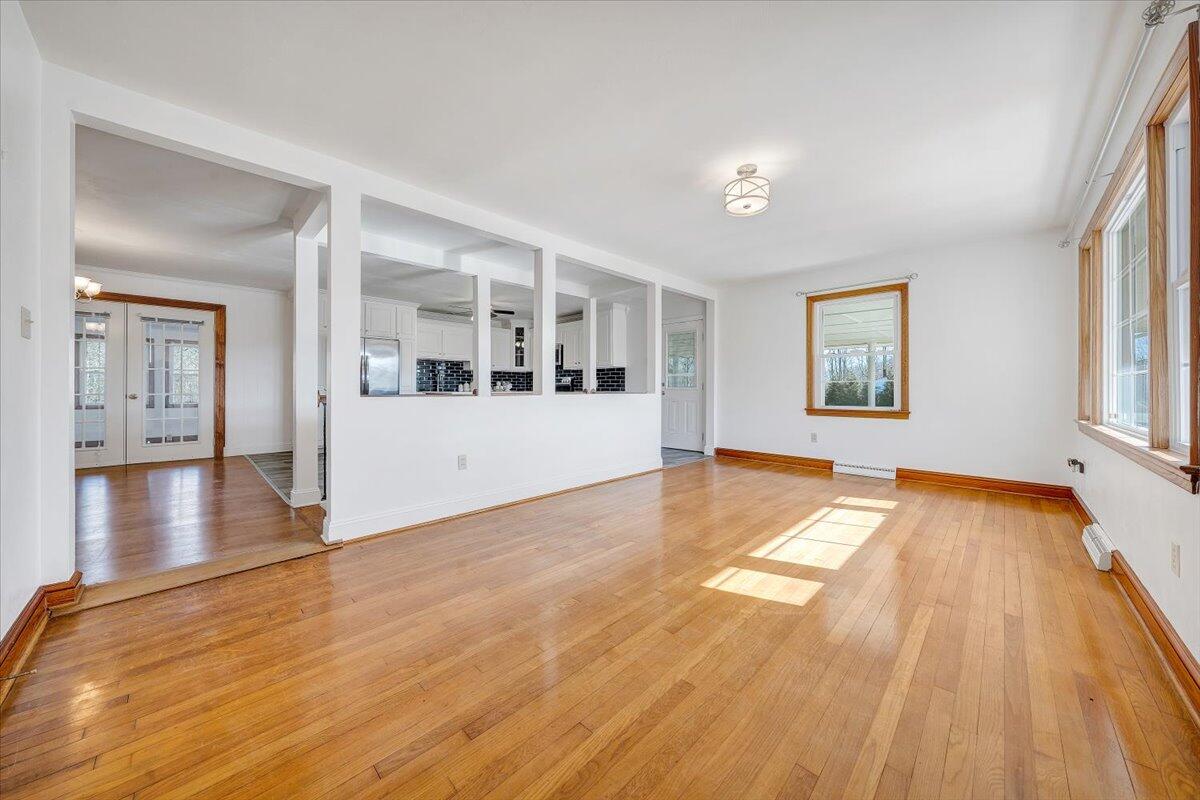 3400 Dillons Fork Road Fieldale, VA 24089 - Photo 17 of 45 a view of empty room with wooden floor and windows
