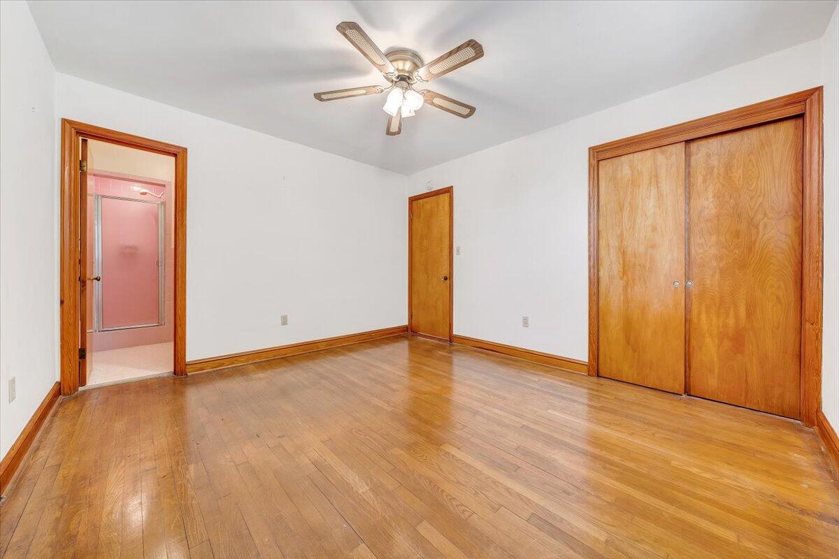 3400 Dillons Fork Road Fieldale, VA 24089 - Photo 24 of 45 an empty room with wooden floor and a ceiling fan