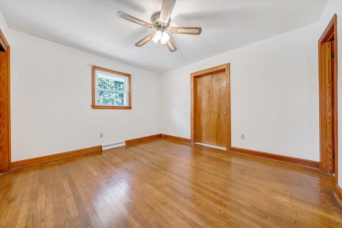 3400 Dillons Fork Road Fieldale, VA 24089 - Photo 25 of 45 a view of an empty room with window and wooden floor