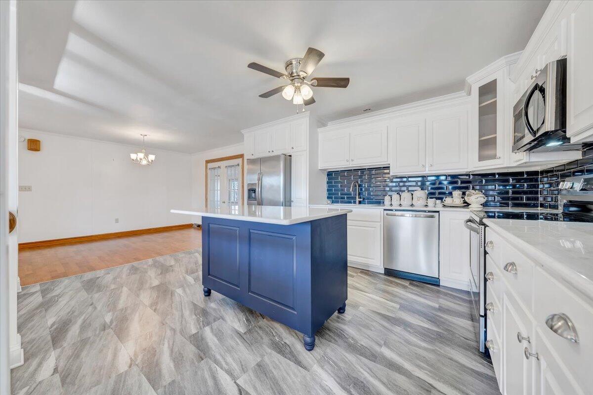 3400 Dillons Fork Road Fieldale, VA 24089 - Photo 4 of 45 a kitchen with stainless steel appliances granite countertop a sink a stove cabinets and wooden floor
