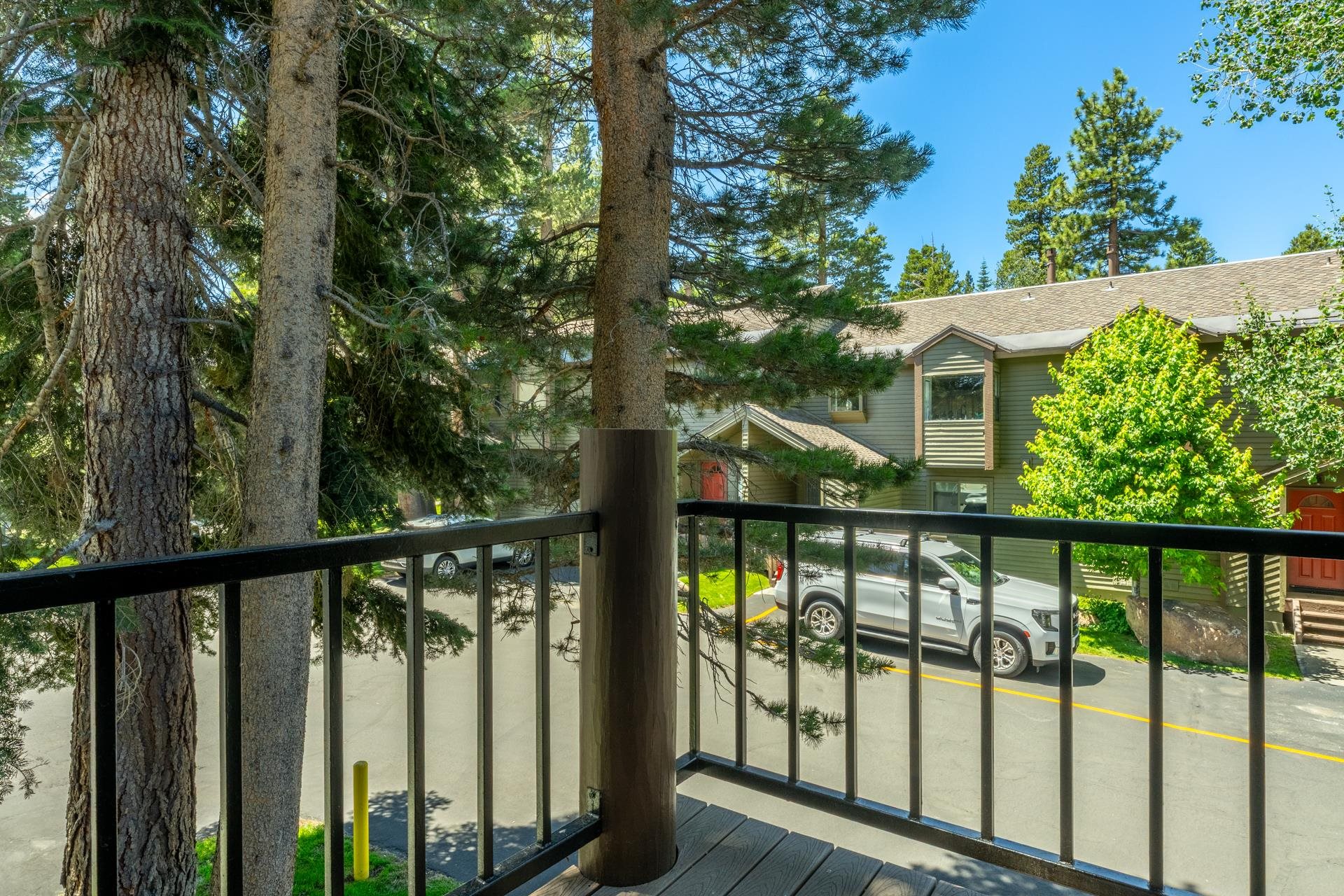 384 Joaquin Road, Unit 36 Mammoth Lakes, CA 93546 - Photo 19 of 36 Balcony with wood-finish flooring and black metal railings