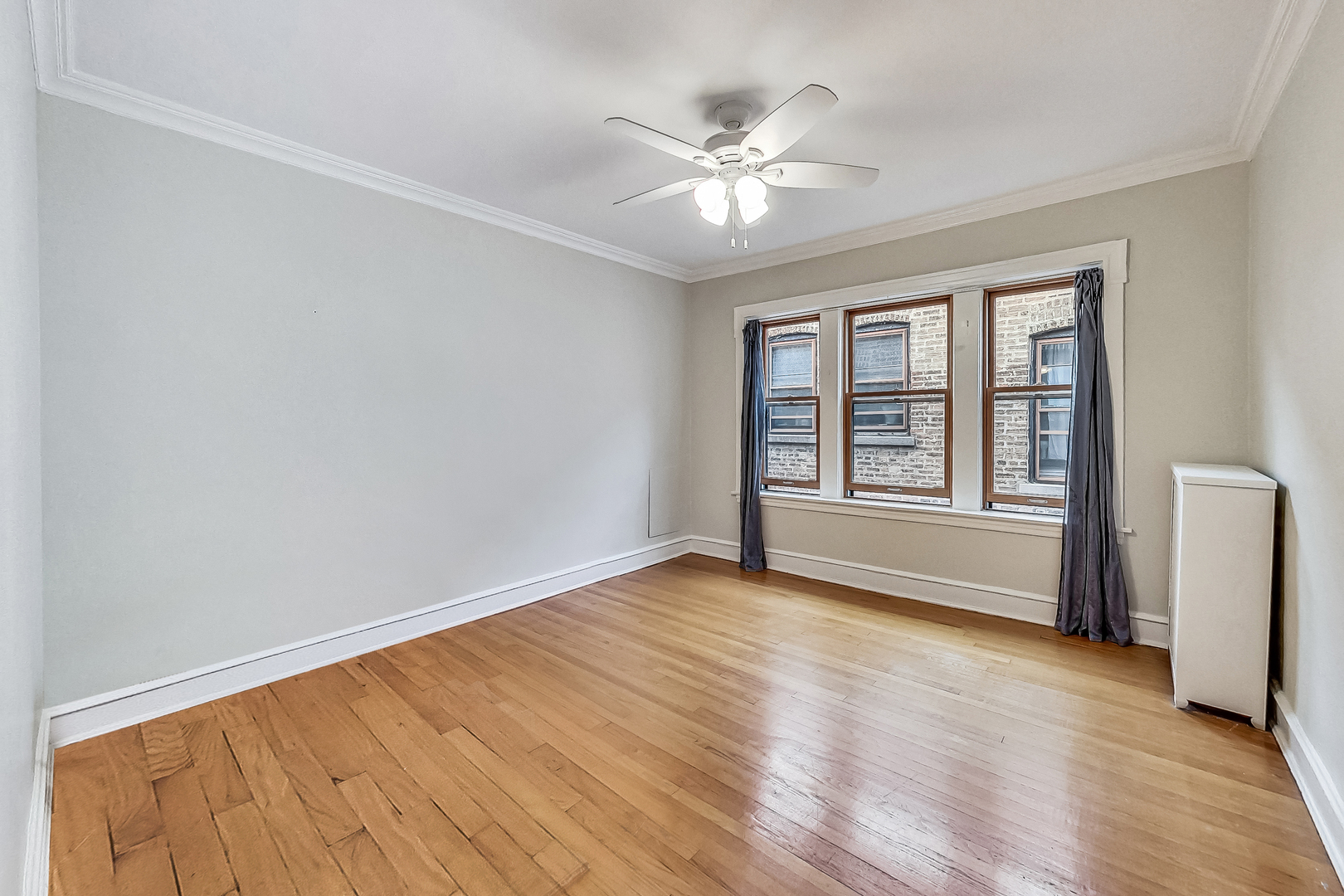 534 Sheridan Road, Unit 3B Evanston, IL 60202 - Photo 12 of 33 a view of an empty room with a window and wooden floor