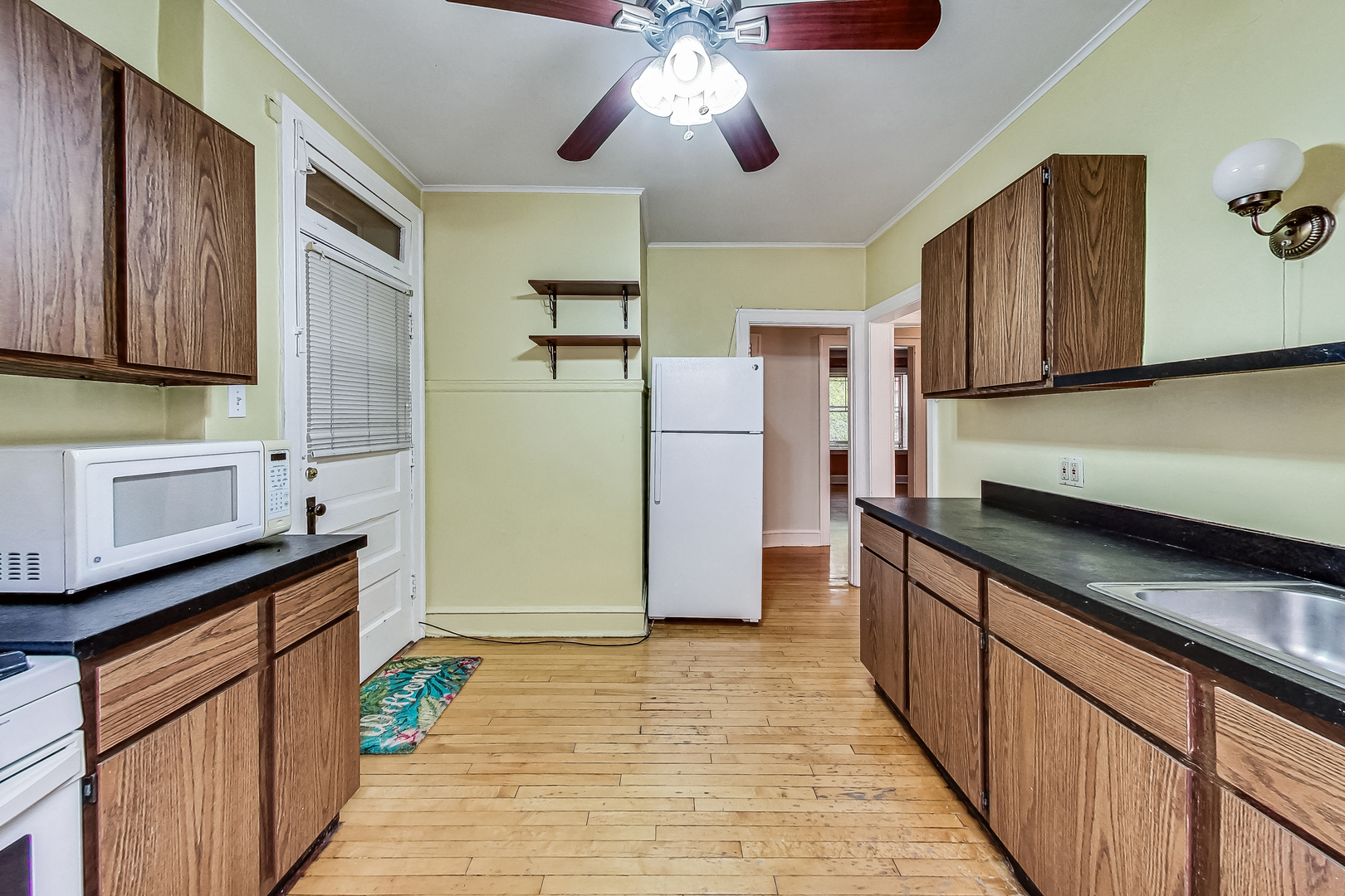 534 Sheridan Road, Unit 3B Evanston, IL 60202 - Photo 32 of 33 a kitchen with stainless steel appliances granite countertop a refrigerator a sink dishwasher a stove and a dining table with wooden floor