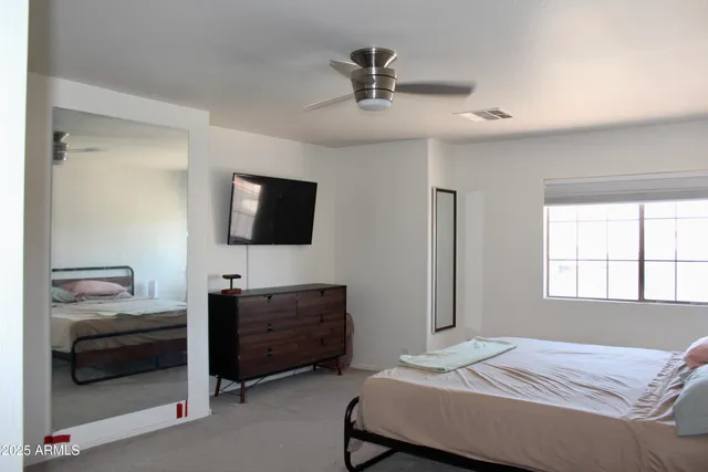 a bedroom with a bed and window